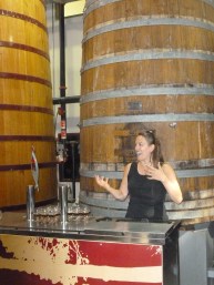 Marie enthusiastically explains barrel aging on the tour