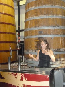 Marie enthusiastically explains barrel aging on the tour