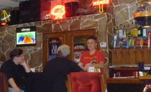 Reg, the night bartender talking to some patrons