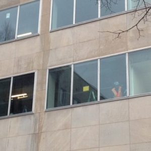 Construction workers now in the windows where famed columnists used to work